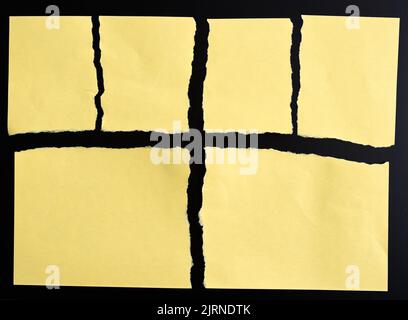 Torn yellow paper on black background Stock Photo