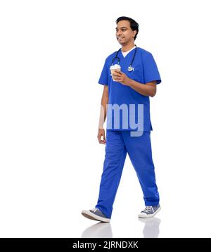 male doctor walking with coffee and stethoscope Stock Photo