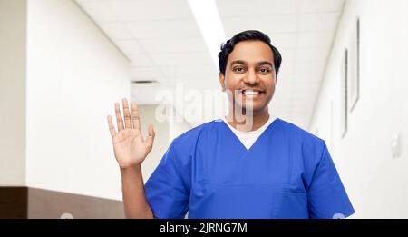happy indian doctor or male nurse waving hand Stock Photo