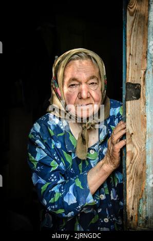 Chernobyl old self-settler woman still living iin her own house within the Chernobyl exclusion zone, few kilometers/miles from Prypiat town, Ukraine Stock Photo