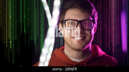 man in glasses over neon lights and binary code Stock Photo