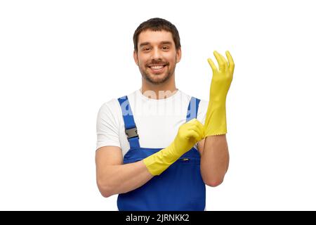male worker or cleaner in overall wearing gloves Stock Photo