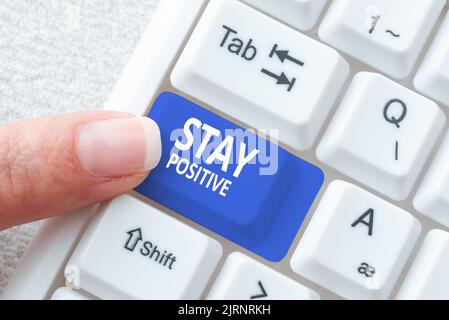 Text sign showing Stay Positive. Word Written on Be Optimistic Motivated Good Attitude Inspired Hopeful Businessman in suit holding notepad Stock Photo