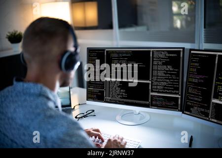 Computer Programmer Writing Program Code On Computer In Office Stock Photo