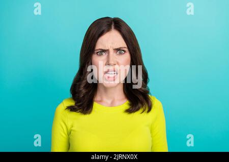 Photo of angry brunette hair millennial lady wear green shirt isolated on teal color background Stock Photo