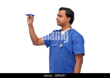 indian male doctor writing something with marker Stock Photo