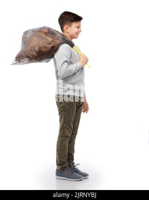 smiling boy with paper garbage in plastic bag Stock Photo