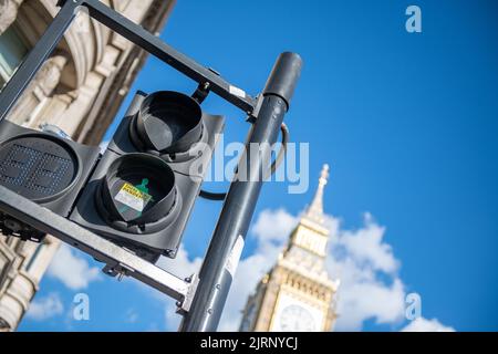 There is no pandemic, sticker on traffic light with Big Ben in the background Stock Photo