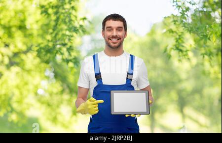 happy male worker or cleaner showing tablet pc Stock Photo