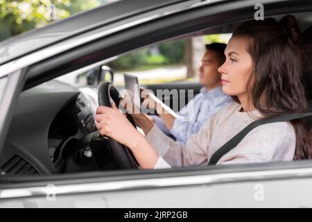 car driving school instructor teaching woman Stock Photo
