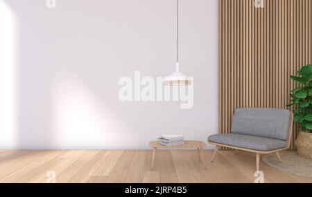 Interior close-up of an armchair with a table that has books on it. In the background a wooden lining. On the table with books there is a light fittin Stock Photo