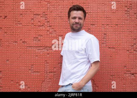 Young confident male model posing with crossed hands Stock Photo