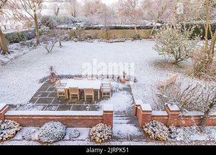 Large UK back garden covered in snow in winter. Snowy backyard scene Stock Photo