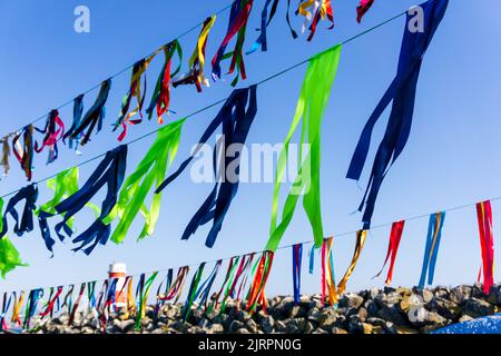 Garlands of multi-colored ribbons against the sky with Stock Photo