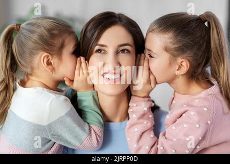 happy mother and daughters gossiping at home Stock Photo