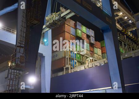 Odessa, Ukraine SIRCA 2019: Container ship at port terminal. Containers loading by crane in night , Trade Port. container operation in port series Stock Photo