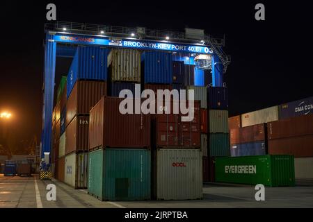 operation of container terminal at night. Unloading container ship at ...