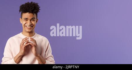 Portrait of creative young smart man with dreads, steeple fingers near chest and smirk devious, have perfect plan, scheming something for april fools Stock Photo