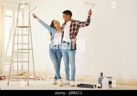 Couple painting room for interior house renovation and home or property design project with smile, white wall background mockup. New home or apartment Stock Photo