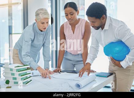 Architect team, 3d and blueprint table for project design illustration evaluation in boardroom. Construction professionals discuss efficiency of Stock Photo