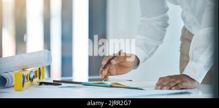 Contractor, creative design engineer and handyman planning home renovation on blueprint, architect writing project strategy in notebook and Stock Photo
