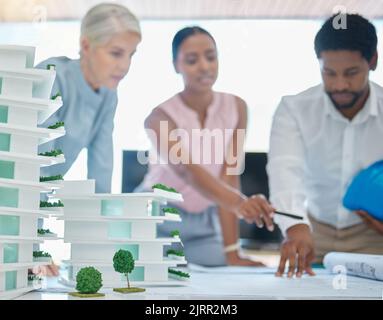 Architect or engineer team planning and designing a building in a meeting in the office or boardroom. City development planner or architecture group Stock Photo