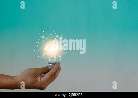 Man holding light bulbs ideas innovation technology and creative business concept. Stock Photo