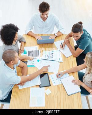 Team, collaboration and documents of business people in teamwork strategy, planning and meeting at the office. Group of workers in research and Stock Photo