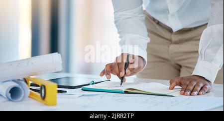 Architect hands drawing architecture sketch design with blueprint, floor plan engineering paper and notebook planning in a studio. Business industry Stock Photo
