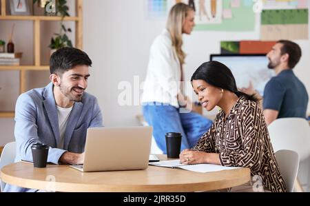 Collaboration, teamwork and strategy meeting for business colleagues sitting at a desk and working together. Happy coworkers writing a growth proposal Stock Photo