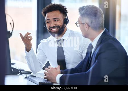 Call center agent or telemarketing employee consulting a business man and talking about company growth. Happy male customer service employee in Stock Photo