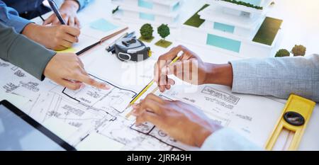 Architect hands working on architecture design, blueprint or floor plan engineering with paper, pencil and planning in office. Business teamwork Stock Photo