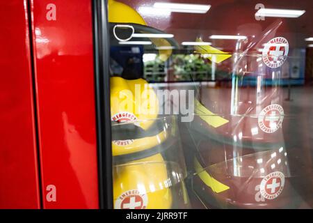 Safety equipment cabinet filled with helmets in public area building Stock Photo