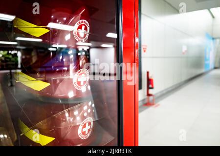 Safety equipment cabinet filled with helmets in public area building Stock Photo