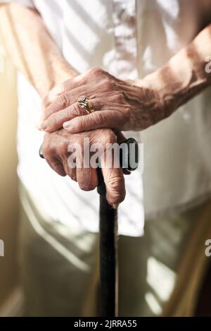 Making mobility possible with a cane. an elderly woman holding onto a cane. Stock Photo