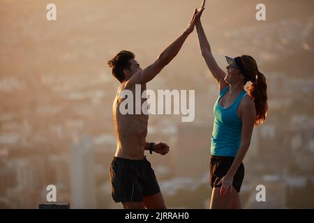 Keeping each other on track. an athletic young couple out for a run in the morning. Stock Photo