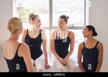 Friends, support and happy ballet dancer group bonding on a break to relax from training in a dance studio. Diverse women laughing and enjoying time Stock Photo