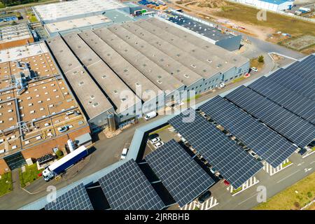 Aerial view of solar panels installed over parking lot with parked cars for effective generation of clean energy Stock Photo