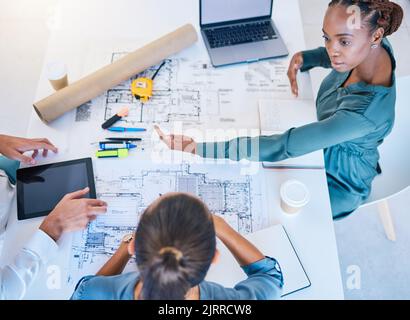 Architects and business woman discuss building project plan, taking notes on laptop and digital tablet. Professional construction and engineering Stock Photo