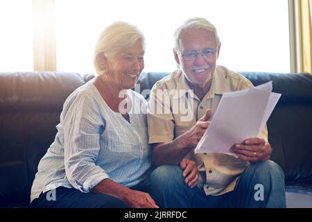 Teamwork makes the finances work. a senior couple going through their paperwork together at home.