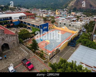 Beautiful aerial view of San Juan la Laguna small town in the Guatemala Atitlan lake - Umbrella Streets, colorful people and tourists Stock Photo