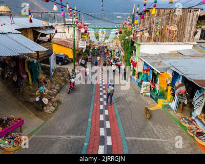 Beautiful aerial view of San Juan la Laguna small town in the Guatemala Atitlan lake - Umbrella Streets, colorful people and tourists Stock Photo