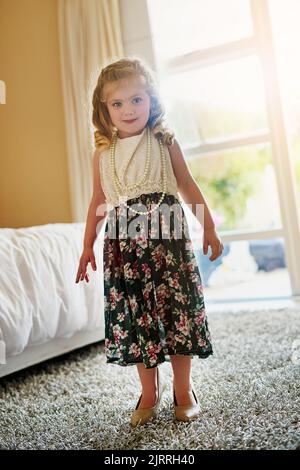 Being this cute comes easy. Portrait of an adorable little girl playing dress-up at home. Stock Photo