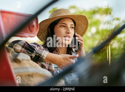 Sustainability farmer, worker and woman on a phone talking and planning a plant growth strategy. Sustainable, eco friendly farm hand on a work call Stock Photo
