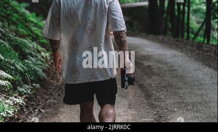 Man from behind photographing nature with a vintage camera Stock Photo