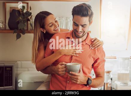 Happy, in love and carefree couple embracing, bonding and being affectionate at home together. Young boyfriend and girlfriend hugging, relaxing Stock Photo