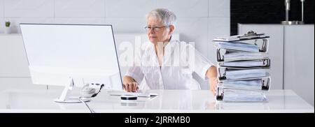 Digital Transformation. Accountant Using E Invoice Tax Document Software Stock Photo