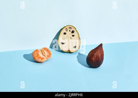Half of sugar-apple, fruit of Annona squamosa cherimoya and figs and mandarin Stock Photo