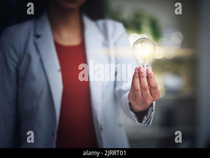 Light bulb, innovation and bright idea with vision, strategy and growth mindset for startup. Closeup hand of leading, thinking and motivated business Stock Photo