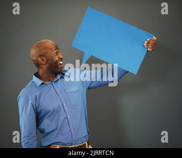 Review, communication and speech bubble with business man marketing, holding and advertising his message on a blank board. Poster, billboard and mock Stock Photo
